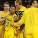 Michigan freshman Nik Stauskas and senior Blake McLimans mob sophomore Trey Burke after Burke hit a three-point shot to tie the game and send it to overtime in the second half at Cowboys Stadium in Arlington, Texas on March 29, 2013. Melanie Maxwell I AnnArbor.com